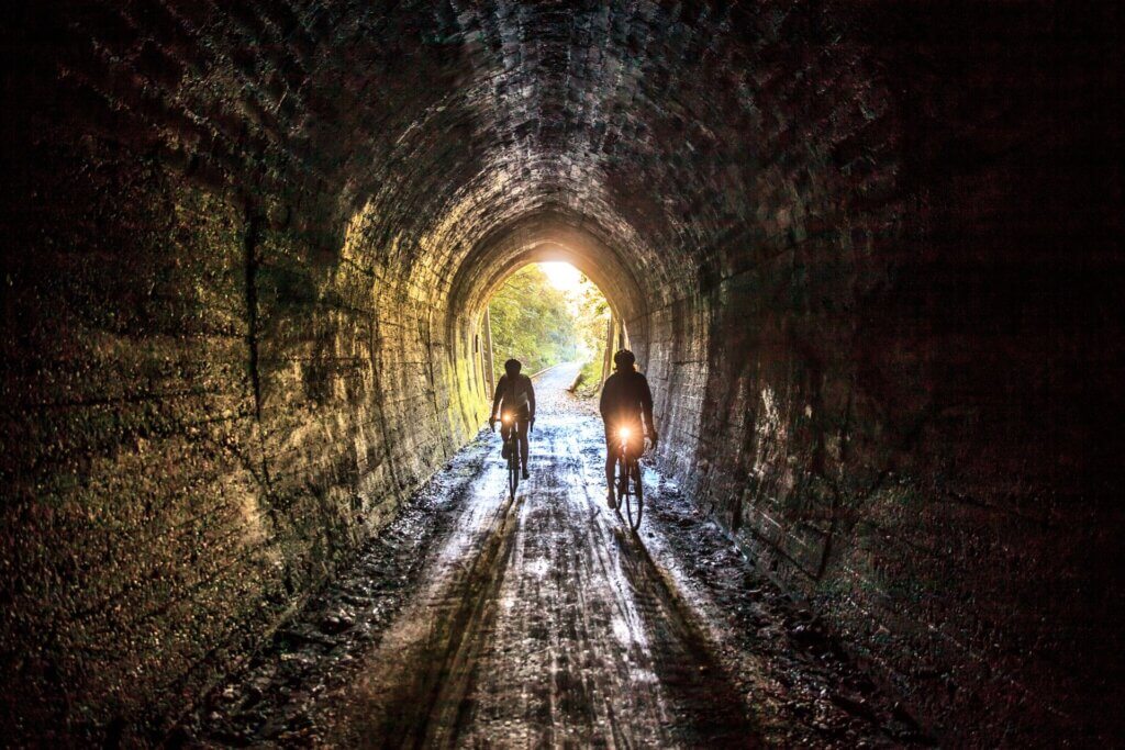 Riding through the historic Spooner Tunnel on the Great Taste Trail