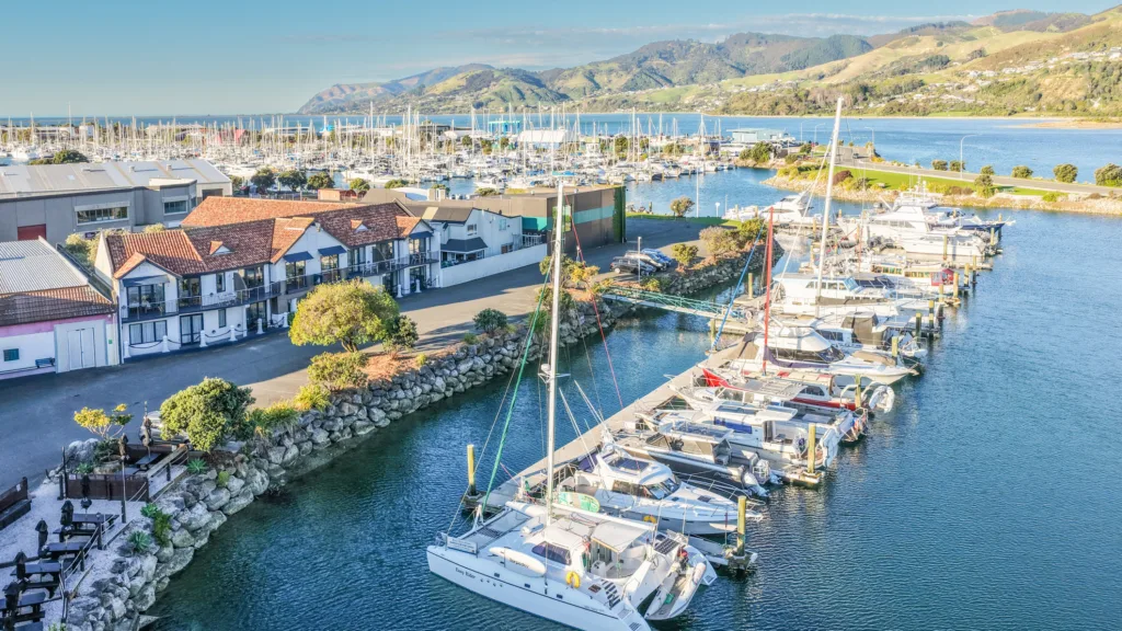 Aerial view of Harbourside Nelson on the edge of Nelson Marina, with moored yachts and hills beyond