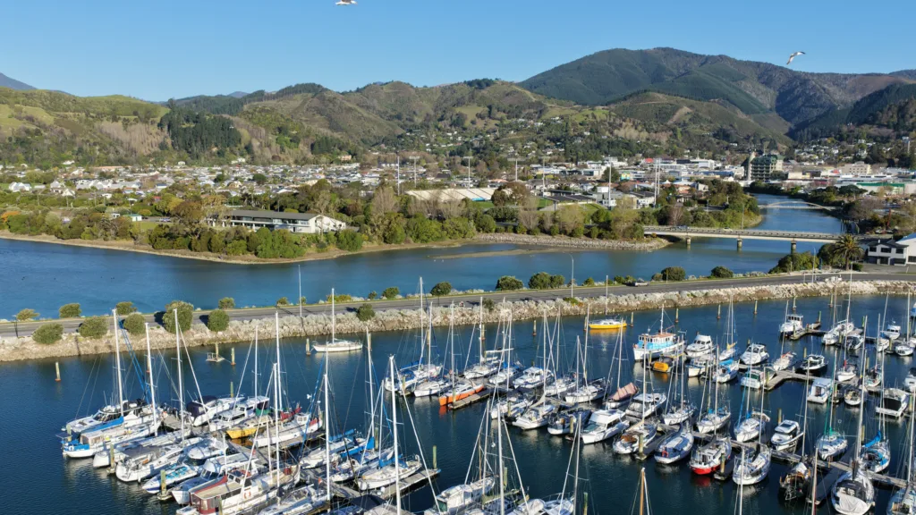 Aerial view over Nelson Marina toward Nelson city, the Maitai River and the hills