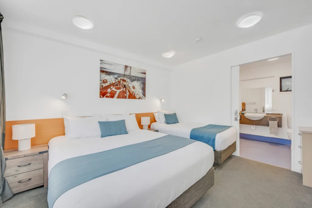 Courtyard Suite bedroom with queen bed, single bed and ensuite