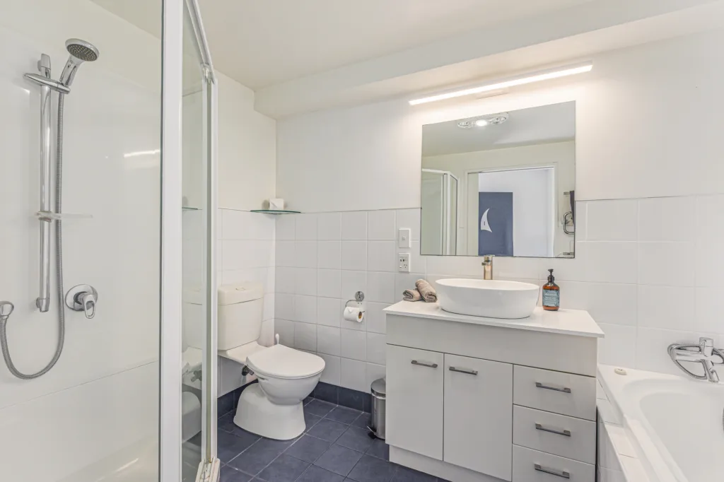 Marina Front Apartment bathroom with separate shower, bath and vanity