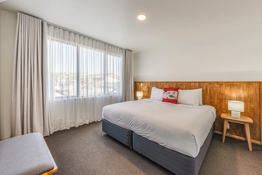 Marina Front Apartment bedroom with super king bed and large window with sheer curtains