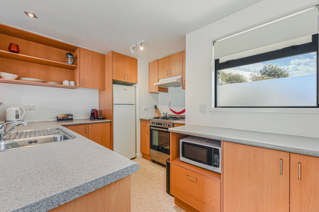 Full kitchen with fridge freezer, oven, microwave and coffee machine