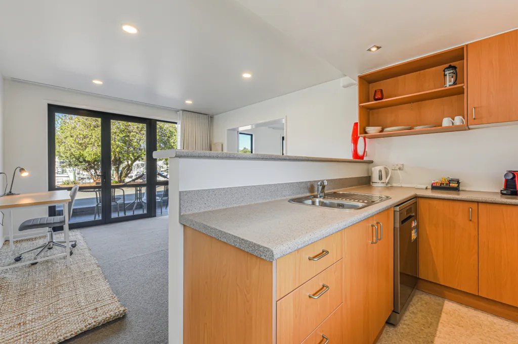 Marina Front Apartment kitchen with dishwasher and breakfast bar, opening to the living area and patio