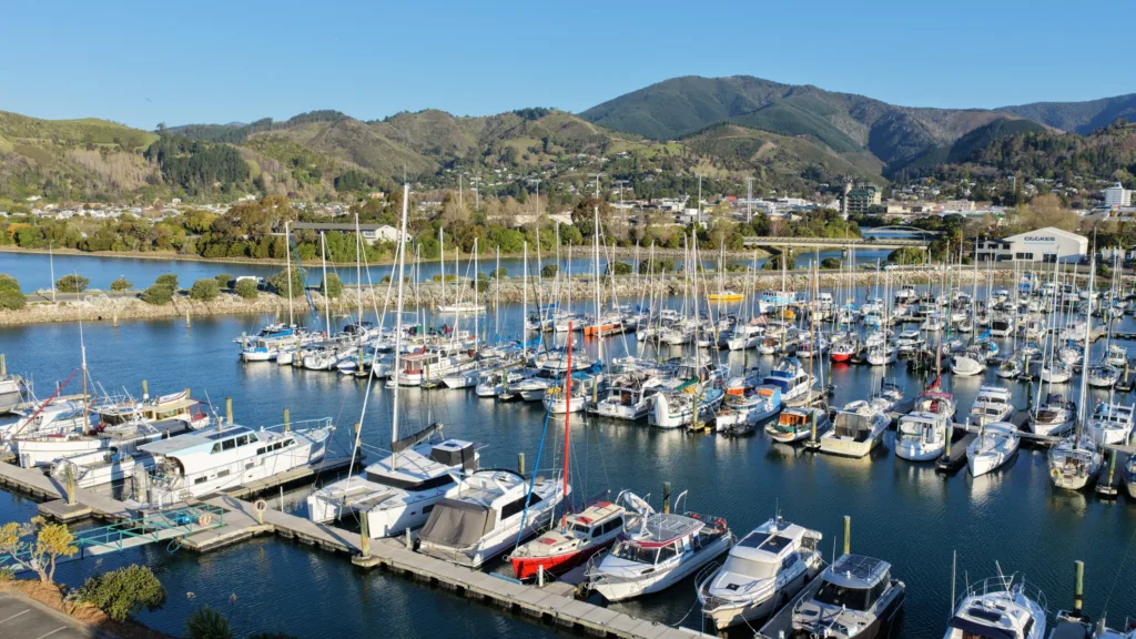 Nelson Marina with moored yachts, the Maitai River and Nelson city backed by hills