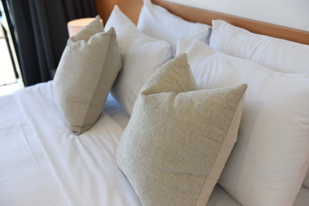 Textured linen cushions on a made bed