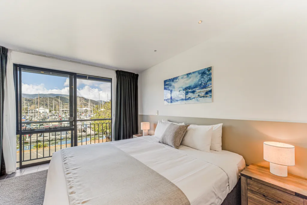 Upper Marina Studio with super king bed and floor-to-ceiling doors opening to a balcony over Nelson Marina